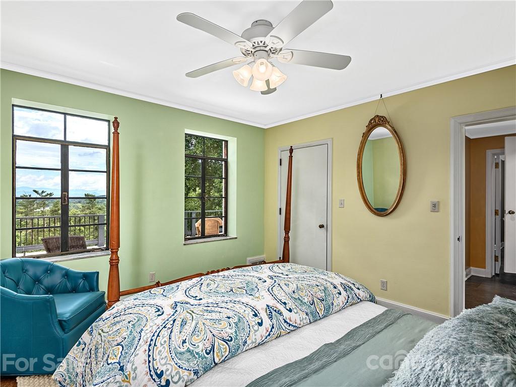 930 Country Club Road Asheville, NC 28804 - Photo 30 of 47 a bedroom with a bed mirror and window