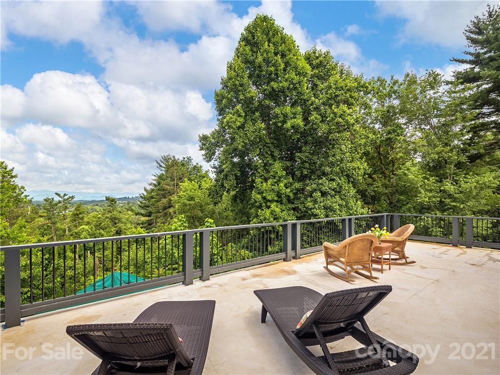 930 Country Club Road Asheville, NC 28804 - Photo 32 of 47 a view of a chair and table on the deck