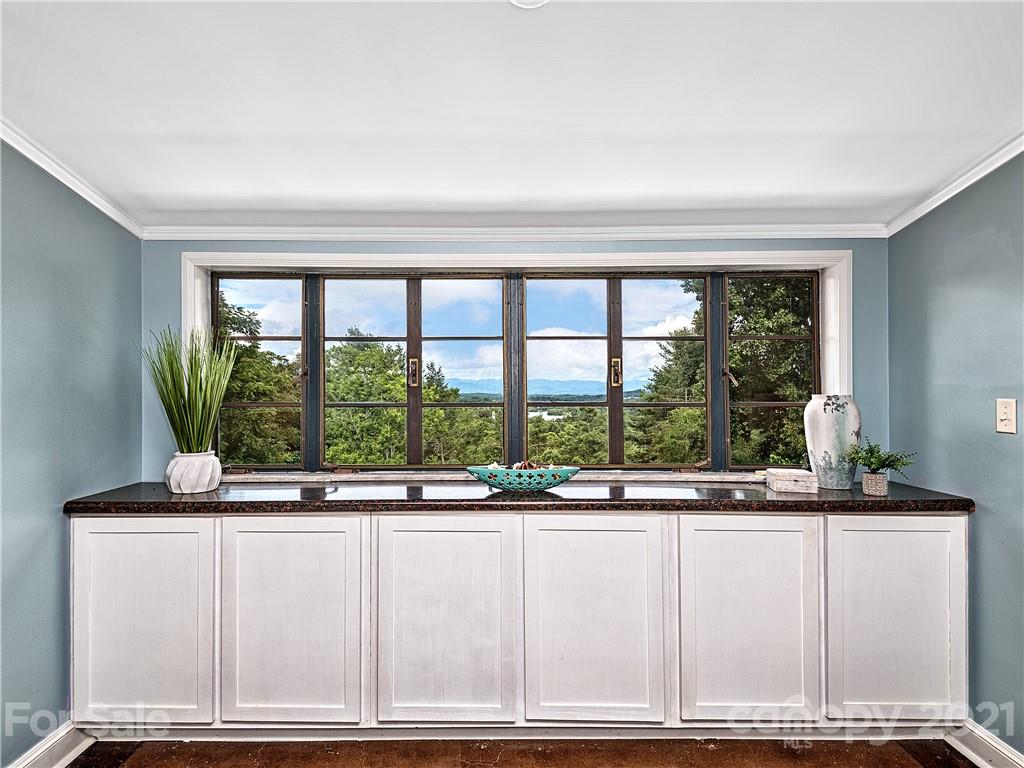 930 Country Club Road Asheville, NC 28804 - Photo 33 of 47 a kitchen with granite countertop a large window and a white counter