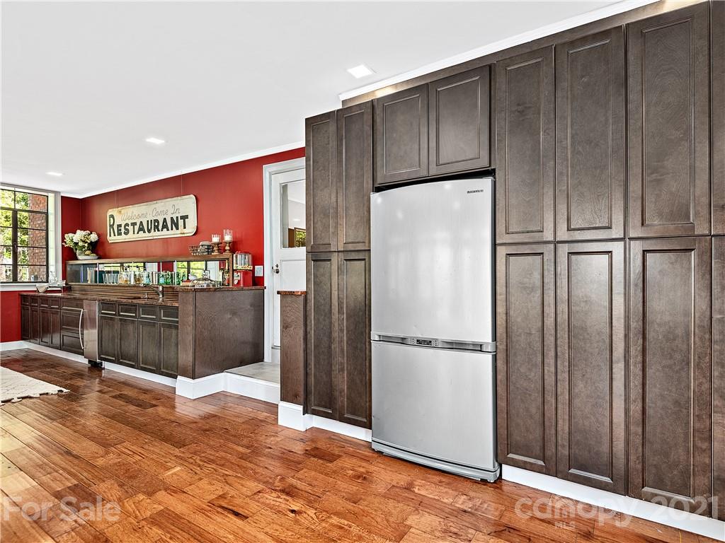 930 Country Club Road Asheville, NC 28804 - Photo 39 of 47 a kitchen with stainless steel appliances a refrigerator and cabinets