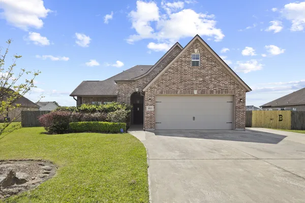 a kitchen with stainless steel appliances granite countertop a sink a stove and a refrigerator with cabinets
