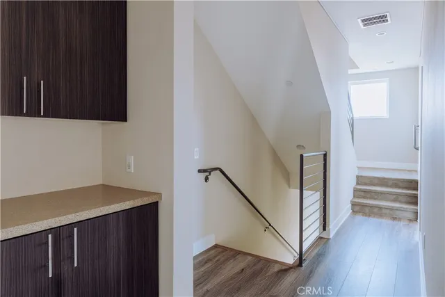 a view of a hallway with wooden floor and entryway