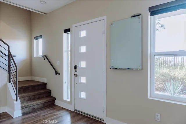 a view of entryway with wooden floor and stairs