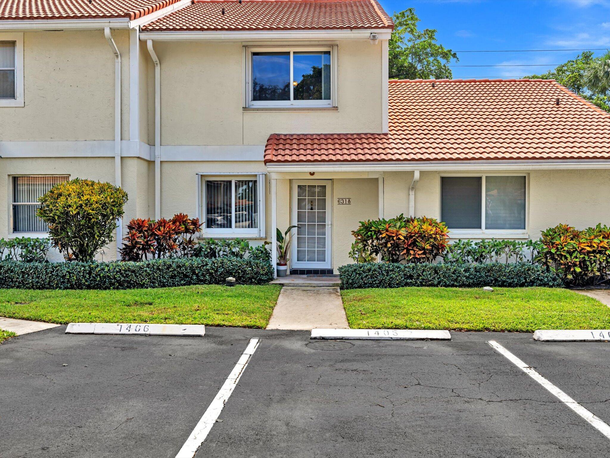 6318 Walk Circle Boca Raton, FL 33433 - Photo 1 of 43 a front view of a house with garden