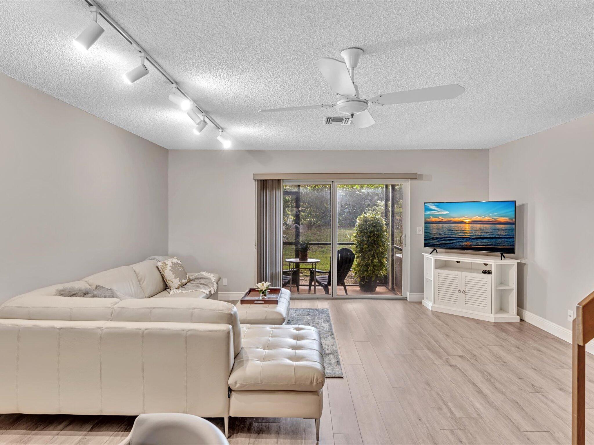6318 Walk Circle Boca Raton, FL 33433 - Photo 13 of 43 a living room with furniture and a flat screen tv