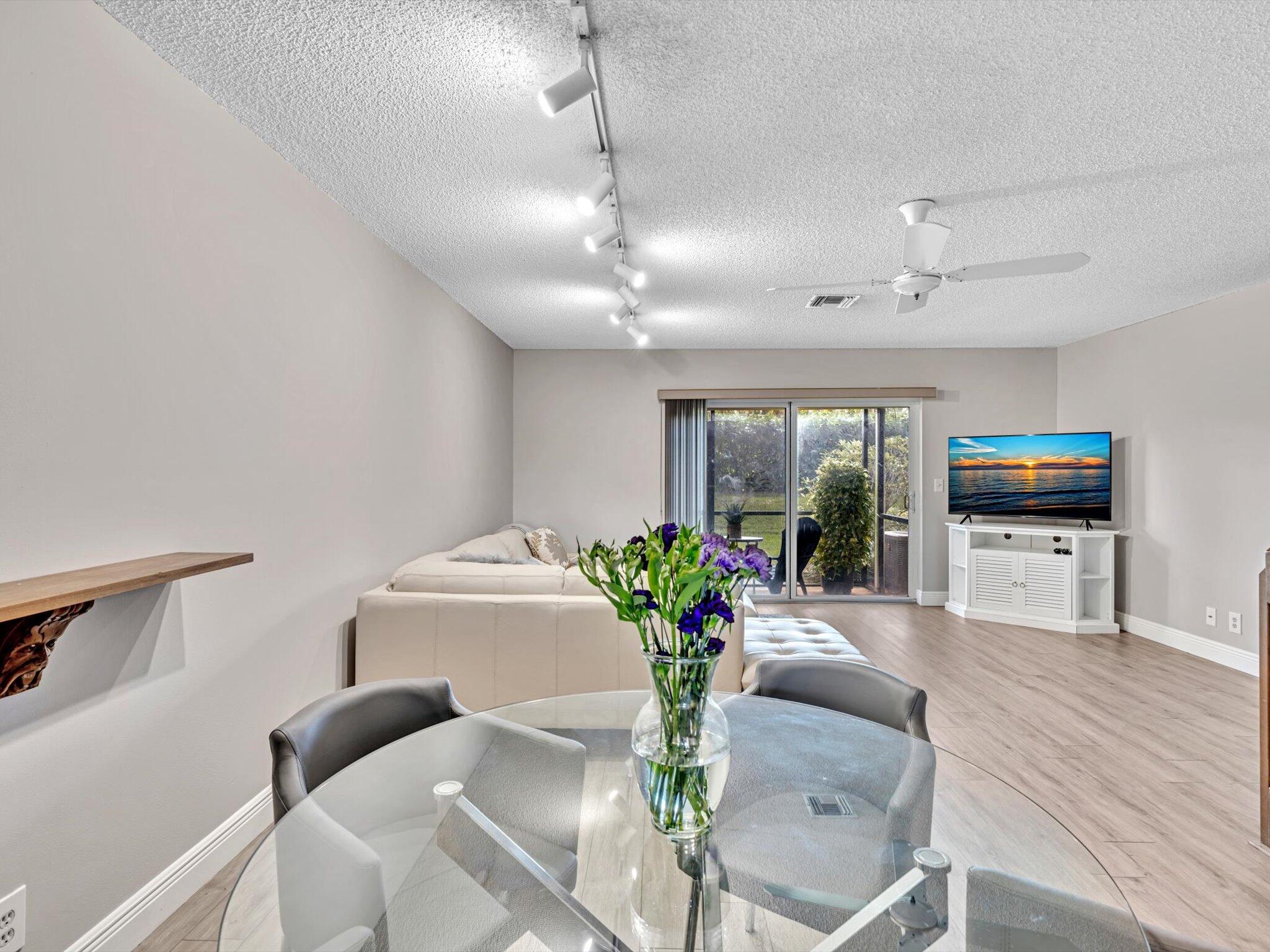 6318 Walk Circle Boca Raton, FL 33433 - Photo 10 of 43 a living room with furniture and a flat screen tv
