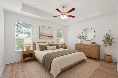 a bedroom with a large bed and a chandelier