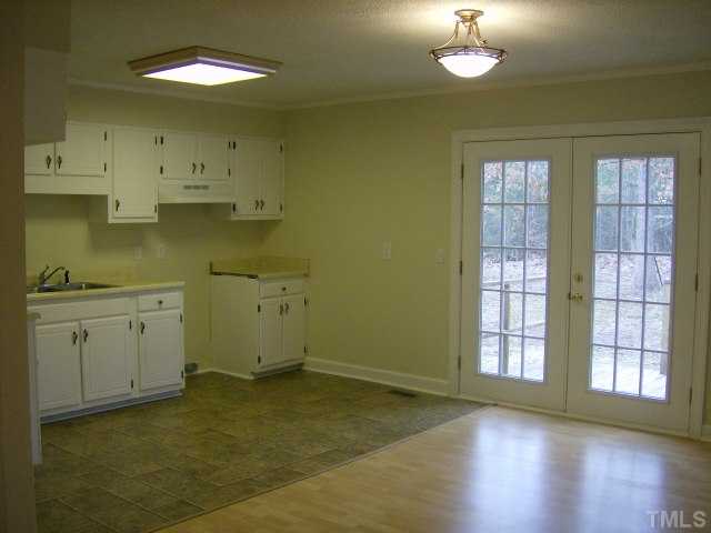 1502 Stone Drive Roxboro, NC 27573 - Photo 3 of 10 a view of a kitchen with wooden floor and a window