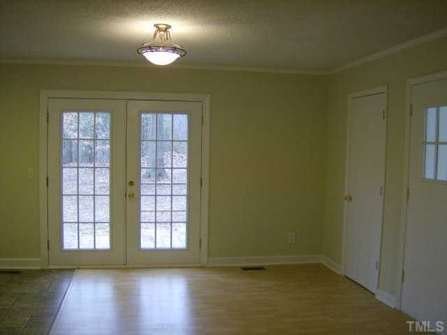 1502 Stone Drive Roxboro, NC 27573 - Photo 4 of 10 wooden floor in an empty room with a window