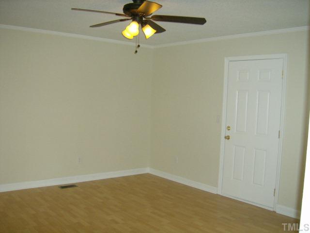 1502 Stone Drive Roxboro, NC 27573 - Photo 5 of 10 an empty room with a window and a fan