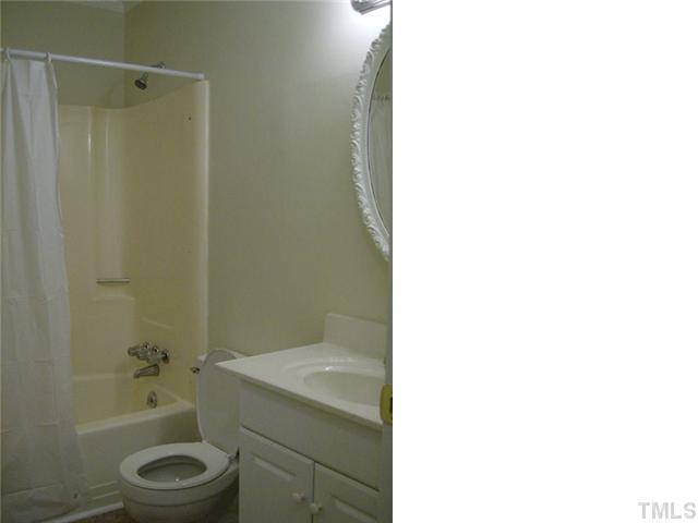 1502 Stone Drive Roxboro, NC 27573 - Photo 7 of 10 a bathroom with a granite countertop toilet a sink and a bathtub