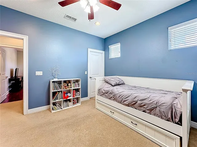 a aerial view of a house with a yard potted plants and a table