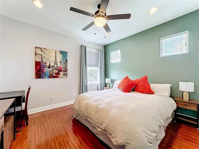 an aerial view of residential houses with outdoor space and trees