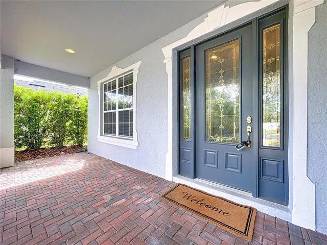 a kitchen with stainless steel appliances kitchen island granite countertop a sink a stove a dining table and chairs