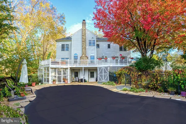 a front view of a house with a yard and potted plants
