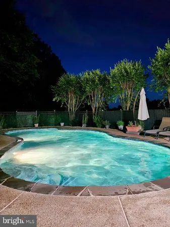 a view of a swimming pool with a yard