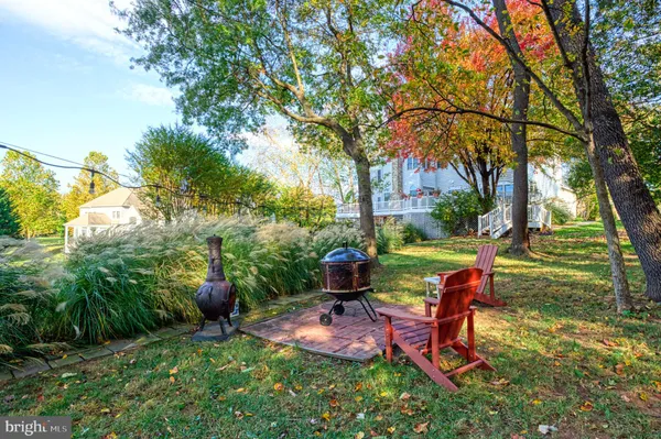 a view of a house with a tree in the yard