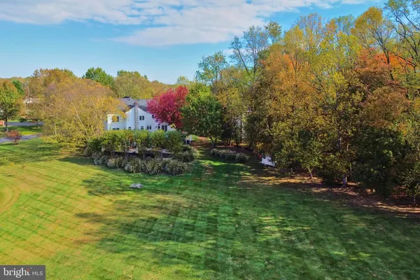 an aerial view of residential houses with yard