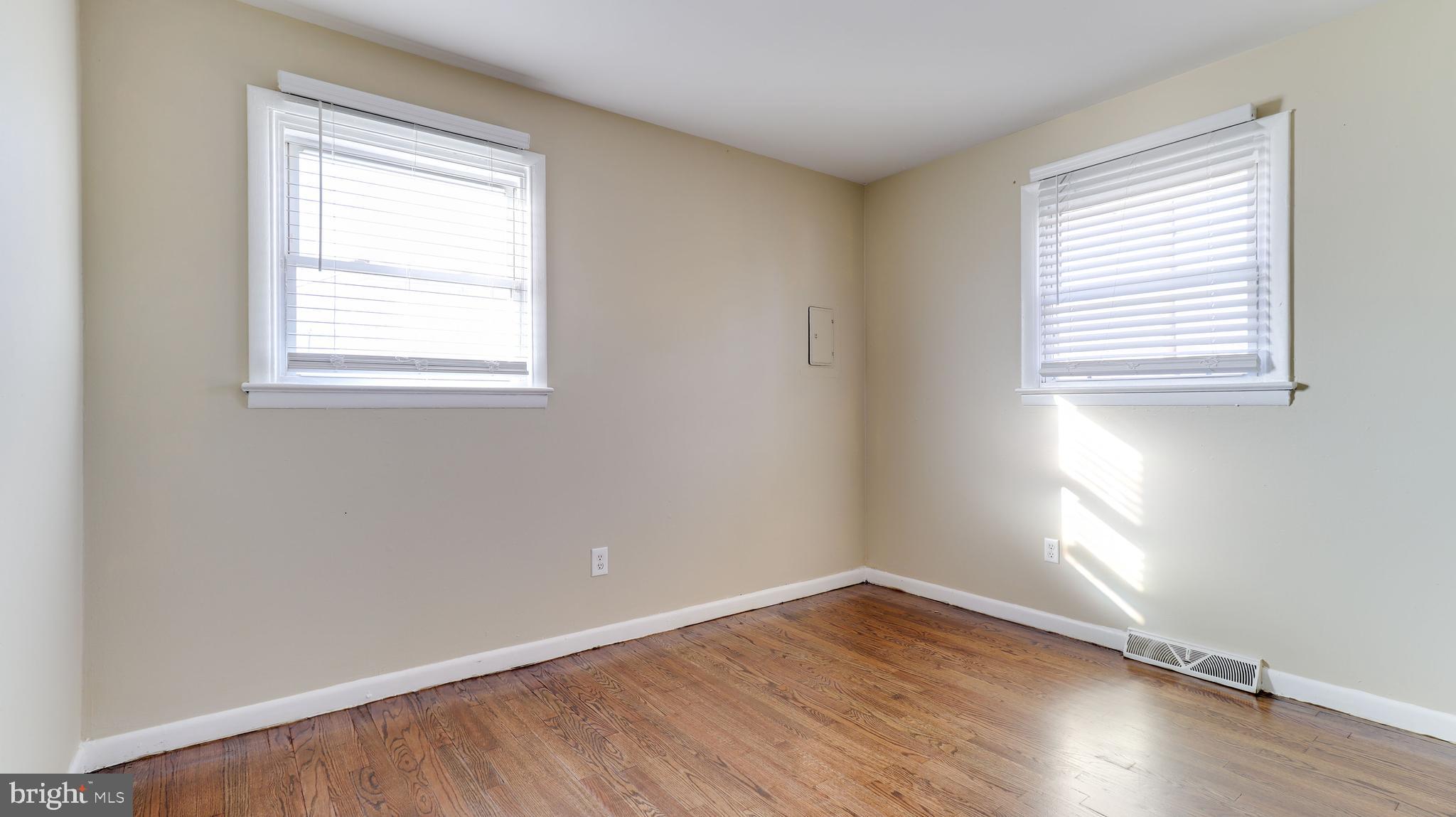 121 Nottingham Road Pennsville, NJ 08070 - Photo 11 of 14 an empty room with wooden floor and windows