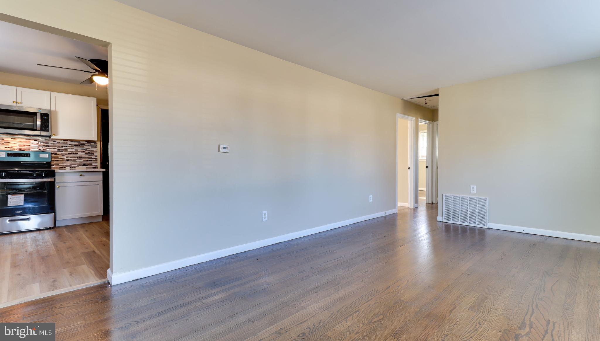 121 Nottingham Road Pennsville, NJ 08070 - Photo 3 of 14 a view of an empty room with wooden floor