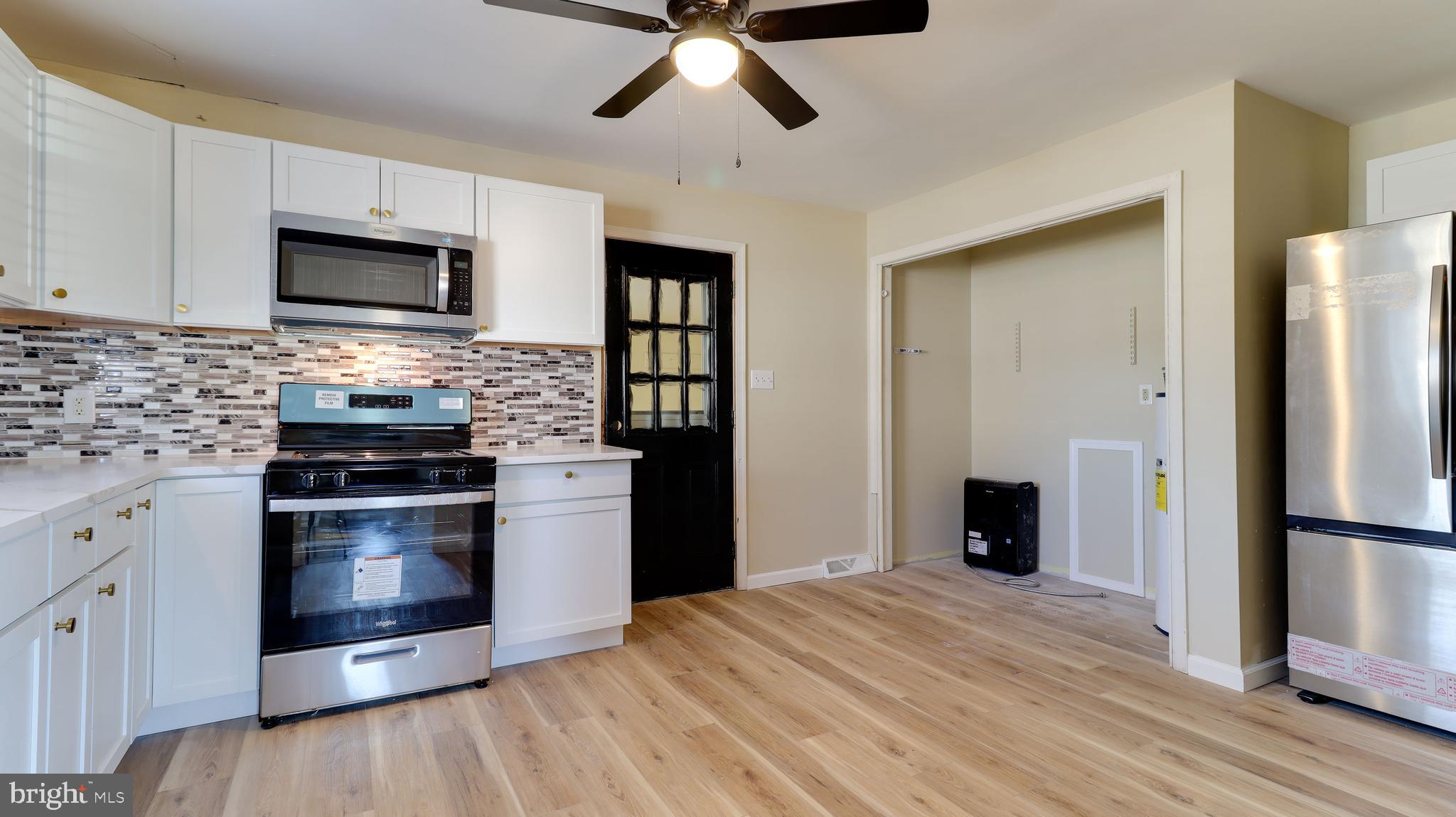 121 Nottingham Road Pennsville, NJ 08070 - Photo 4 of 14 a kitchen with stainless steel appliances granite countertop a stove and a refrigerator