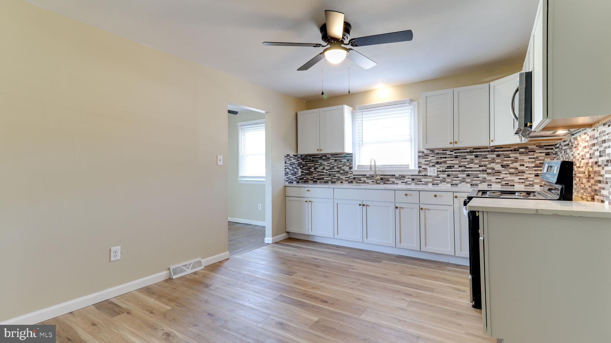 121 Nottingham Road Pennsville, NJ 08070 - Photo 5 of 14 a kitchen with granite countertop white cabinets and white appliances