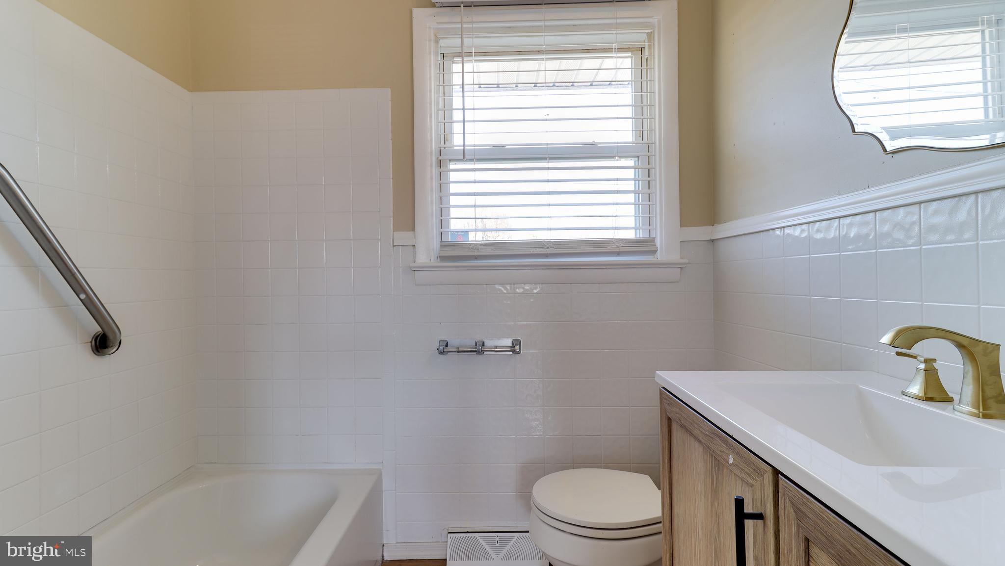 121 Nottingham Road Pennsville, NJ 08070 - Photo 8 of 14 a bathroom with a sink a toilet and window