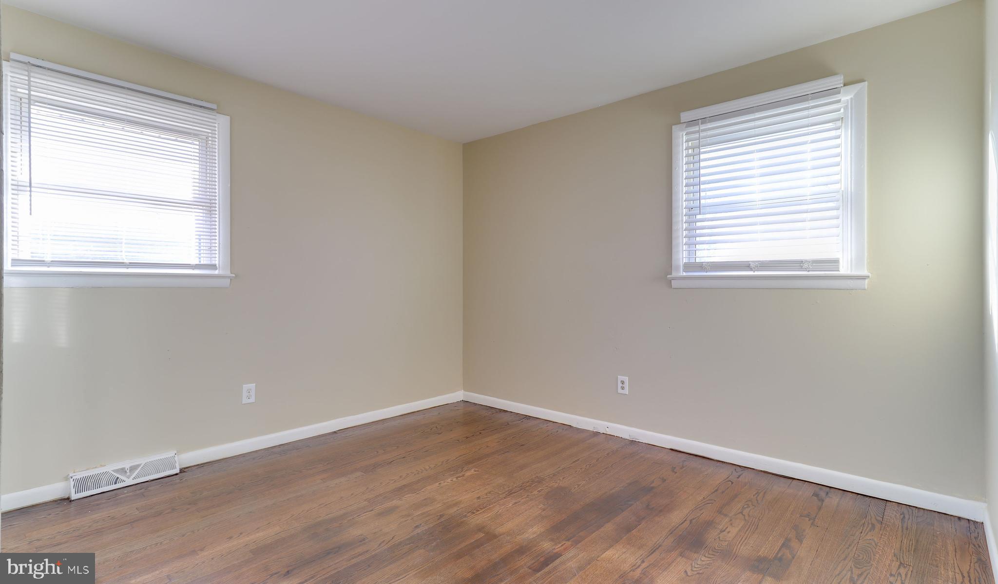 121 Nottingham Road Pennsville, NJ 08070 - Photo 9 of 14 a view of an empty room with wooden floor and a window