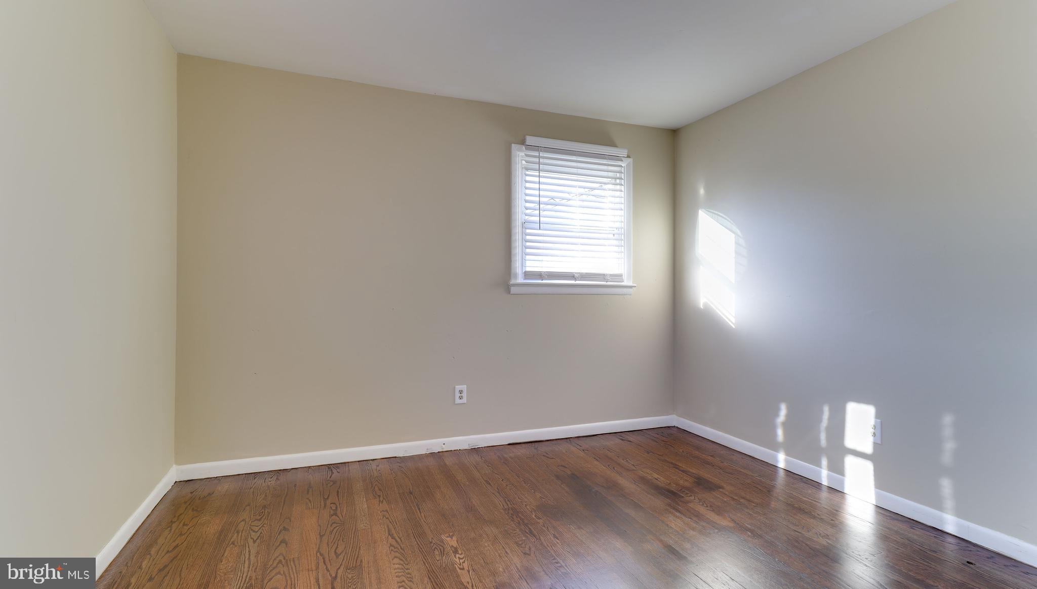 121 Nottingham Road Pennsville, NJ 08070 - Photo 10 of 14 an empty room with wooden floor and windows