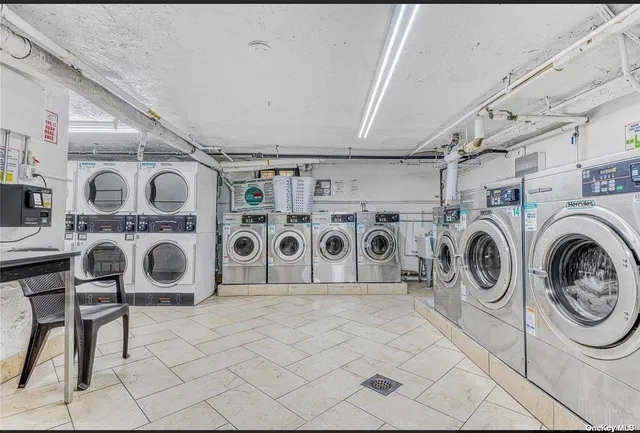 a utility room with multiple dryer and washer