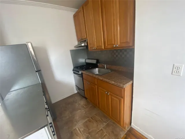 a kitchen with stainless steel appliances granite countertop a sink stove and refrigerator