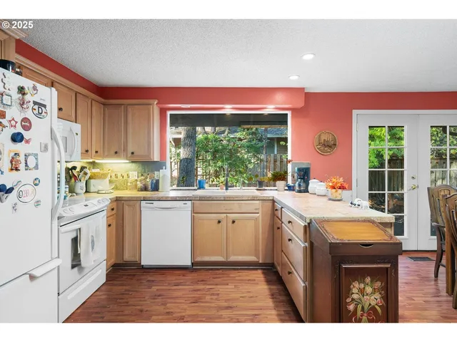 a kitchen with a stove a sink and a refrigerator