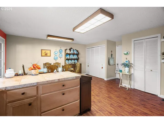a hallway with wooden floors and cabinet