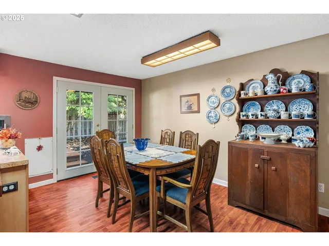 a view of a dining room with furniture a chandelier and wooden floor