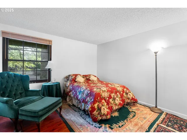 a bedroom with bed and a window