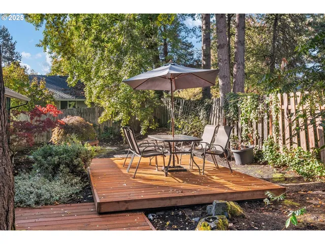 a view of a patio with table and chairs under an umbrella