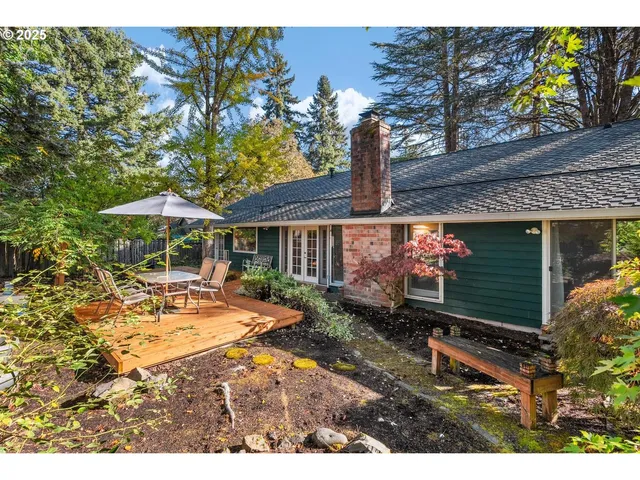 a backyard of a house with barbeque oven table and chairs