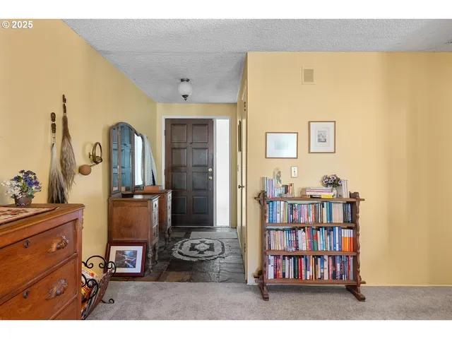 a view of a workspace with furniture and natural light