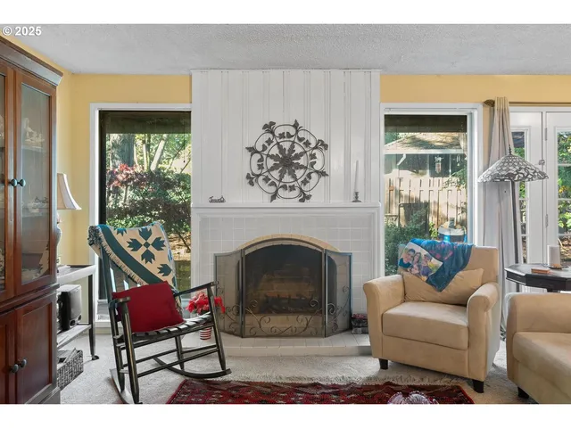 a living room with furniture a fireplace and a flat screen tv