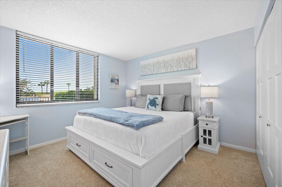 100 Ocean Trail Way, Unit 107 Jupiter, FL 33477 - Photo 17 of 34 Guest Bedroom - king bed
