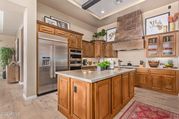a kitchen with stainless steel appliances granite countertop a refrigerator and a sink