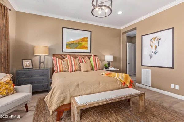 a bedroom with a bed and wooden floor