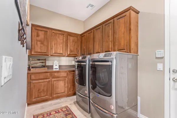 a utility room with sink dryer and washer