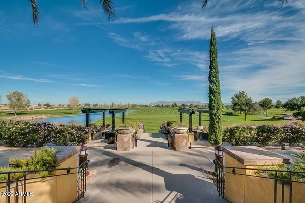 a living room with furniture a chandelier and a large window
