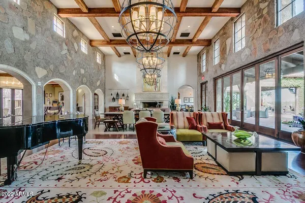 a living room with furniture a piano and a flat screen tv
