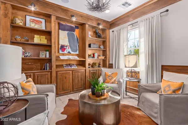 a living room with furniture and a potted plant