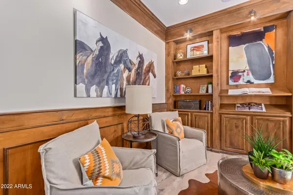 a living room with furniture and painting on the wall