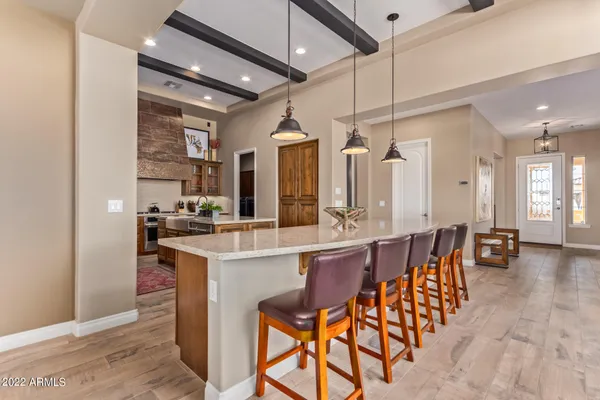 a large kitchen with a table and chairs