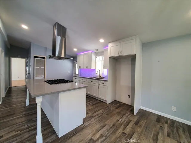an open kitchen with sink and stainless steel appliances