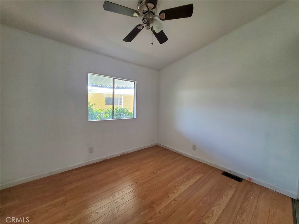 27361 Sierra Highway, Unit 19 Canyon Country, CA 91351 - Photo 15 of 26 an empty room with chandelier fan and windows